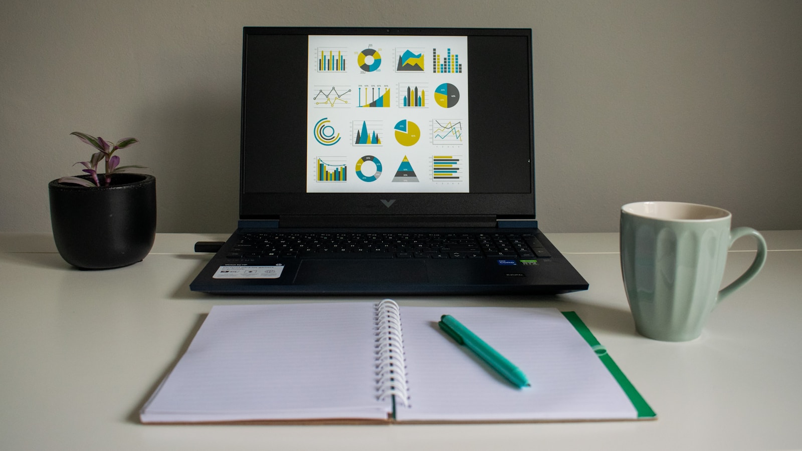 A laptop displaying a collection of business charts and reports